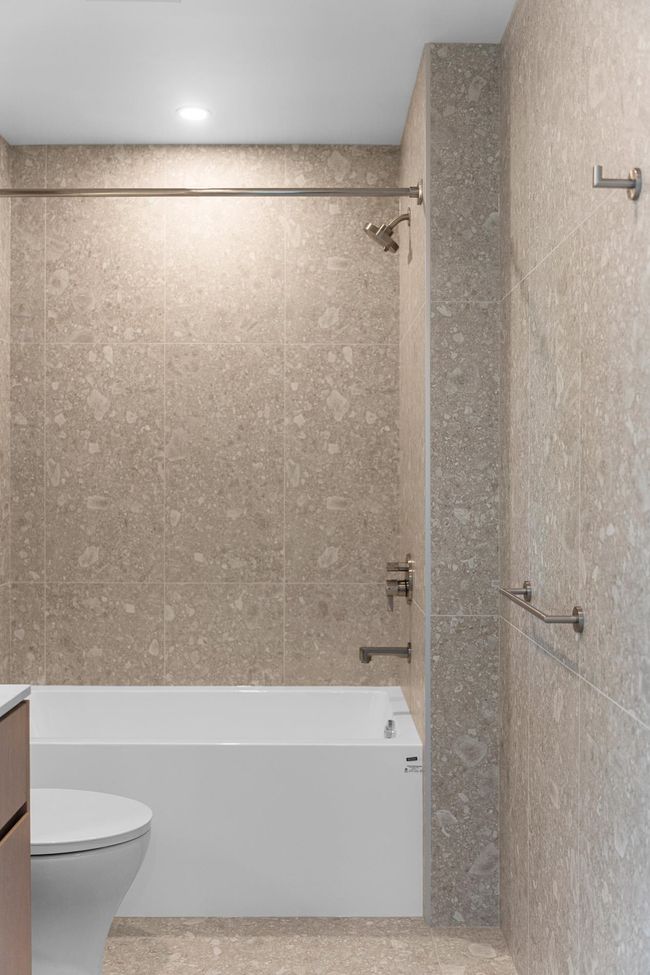 Full bathroom featuring bathing tub / shower combination and vanity | Image 12