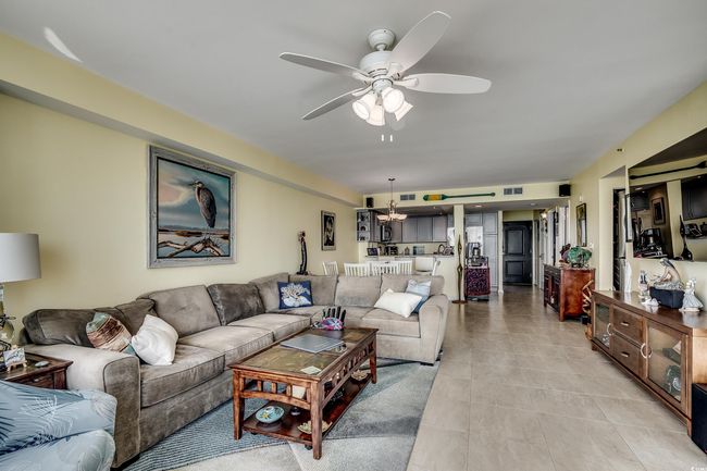 Living area featuring ceiling fan and light tile patterned floors | Image 10