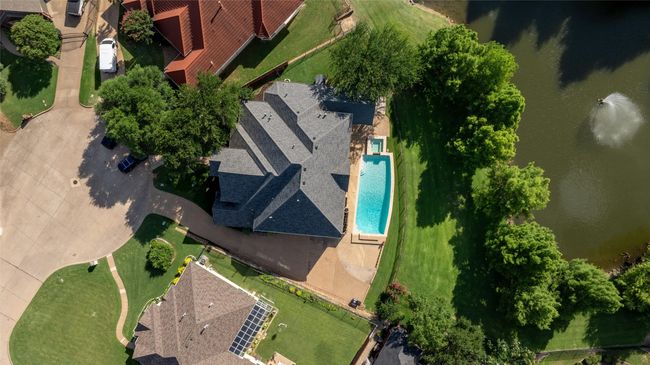 Aerial view of a pool and a large body of water | Image 4