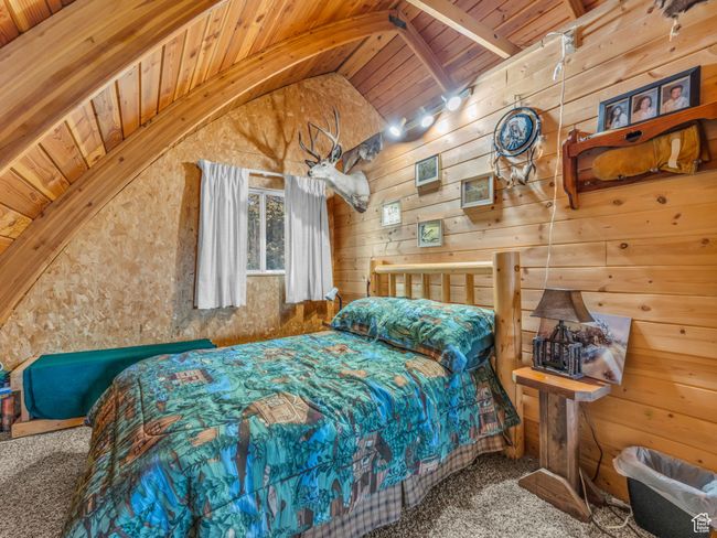 Bedroom featuring wood ceiling, carpet floors, and wood walls | Image 19