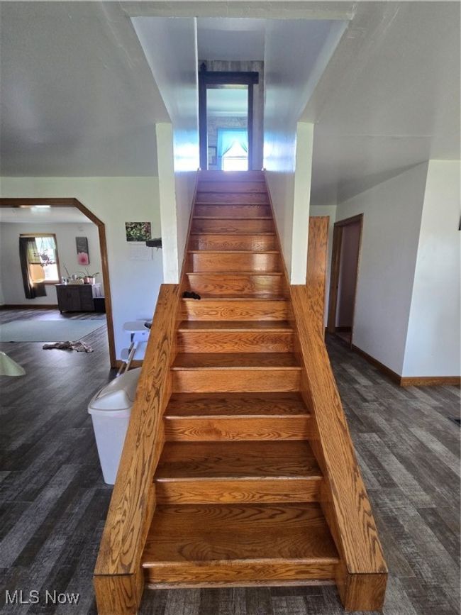 Stairs featuring baseboards and wood finished floors | Image 14