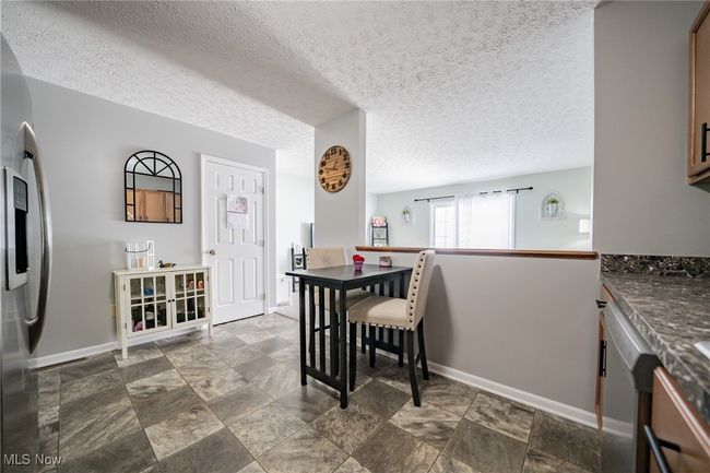 Tiled dining area with a textured ceiling | Image 8