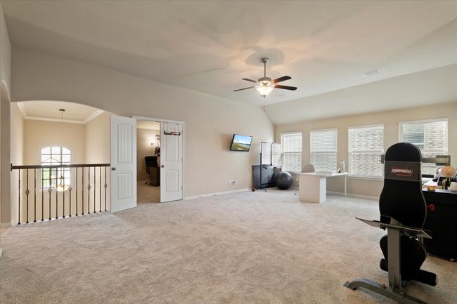 Office featuring ceiling fan, baseboards, light carpet, and crown molding | Image 21