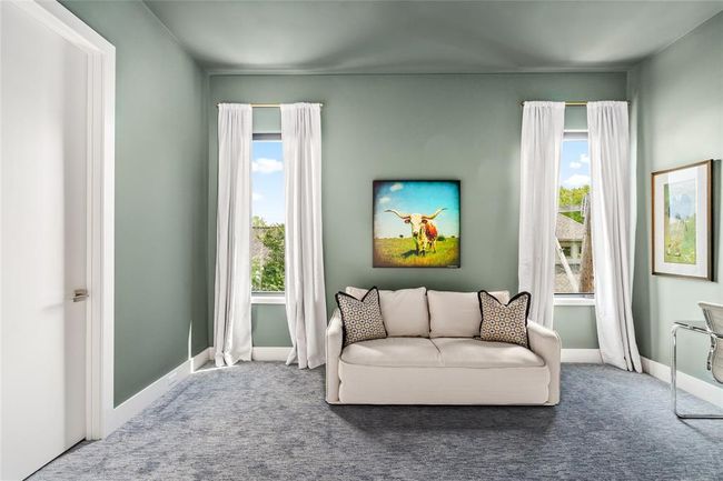 An alternate view of the third-floor bedroom or office reveals great natural light from dual windows and plenty of space to relax or work in comfort. The flexible layout easily adapts to your lifestyle needs. | Image 32