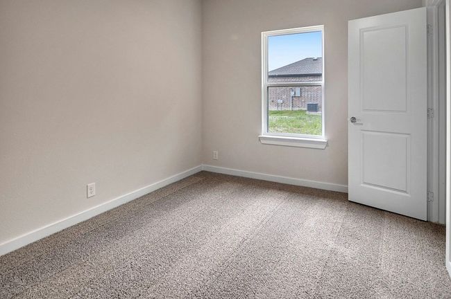 Carpeted spare room with baseboards | Image 23