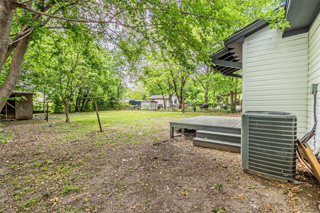 View of yard with central air condition unit, fence, and a deck | Image 24