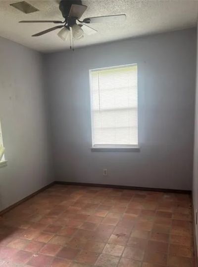 Empty room featuring ceiling fan | Image 2