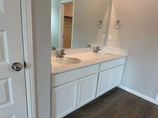 Bathroom with double vanity and wood finished floors | Image 8