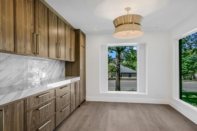 Breakfast area with natural light and walnut wood shelving | Image 12