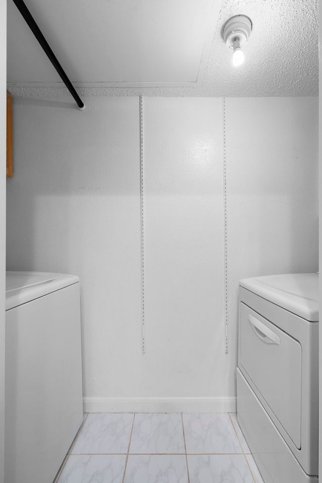 Clothes washing area with laundry area, marble finish floor, baseboards, and washer and clothes dryer | Image 15