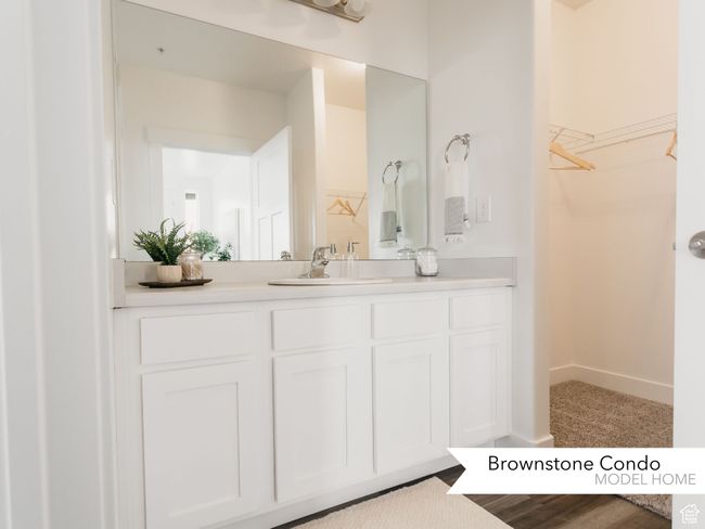 Bathroom with a spacious closet, baseboards, and vanity | Image 17