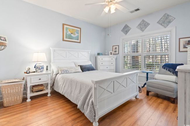 Bedroom with a ceiling fan, light wood-style floors, and visible vents | Image 21