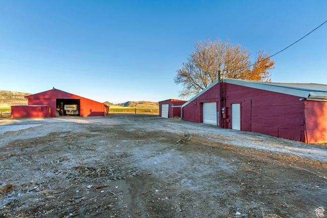 Shop building on the right, one-car garage in the middle, and barn on the left | Image 9