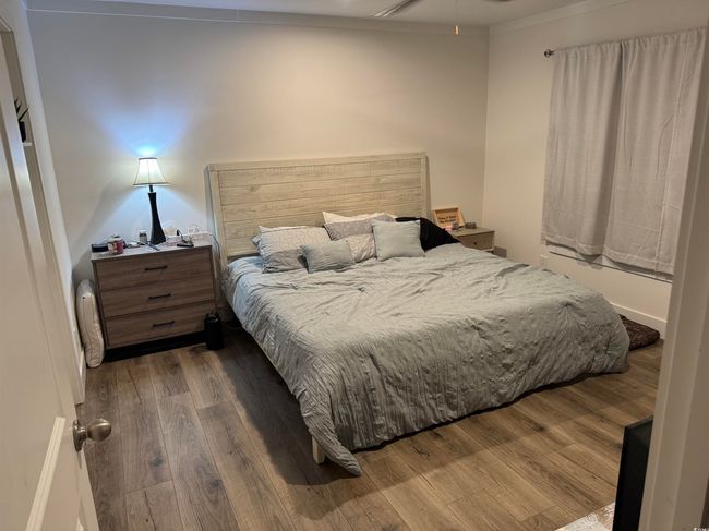 Bedroom with wood finished floors | Image 16