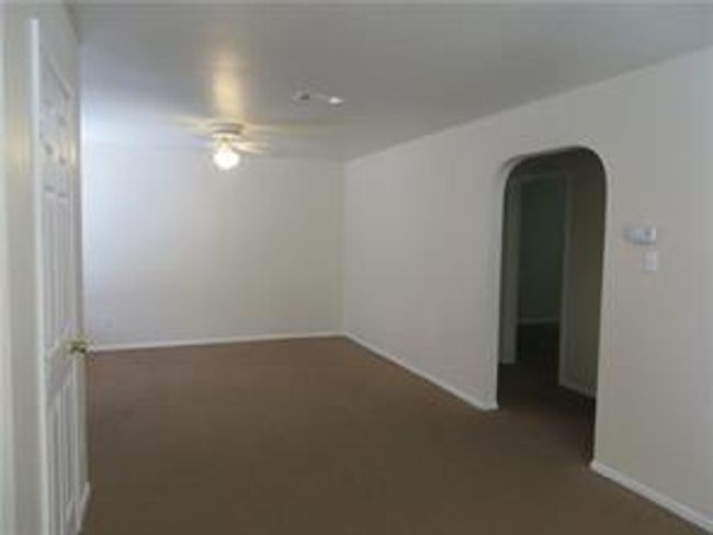 Living room with arched walkways and ceiling fan | Image 4