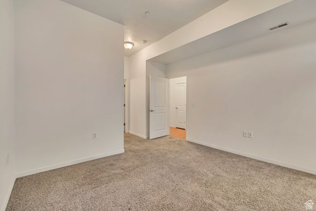 Spare room featuring baseboards, visible vents, and light colored carpet | Image 18