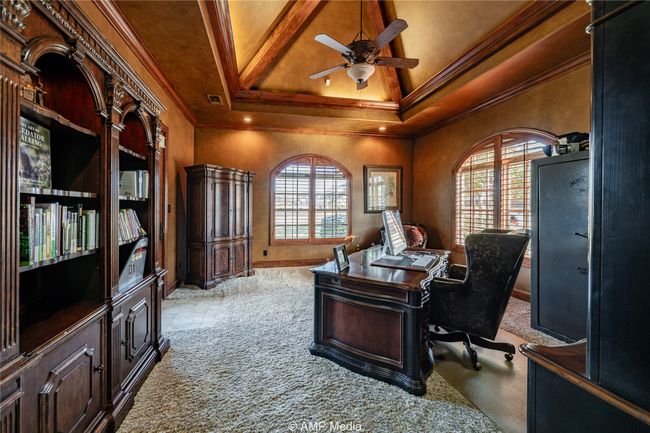 Office space with light carpet, a raised ceiling, ceiling fan, and ornamental molding | Image 8