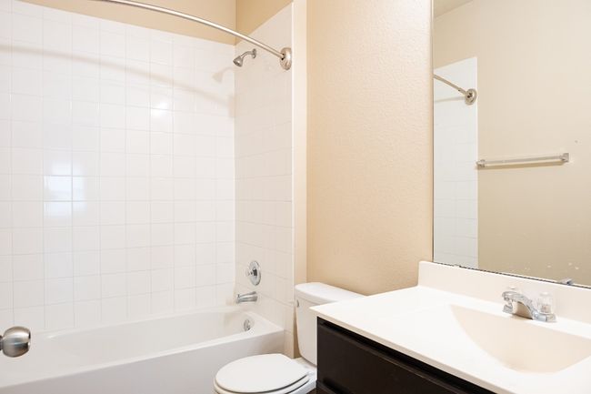 Full bath featuring toilet, vanity, and shower / washtub combination | Image 16