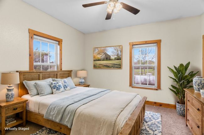 Bedroom featuring carpet floors, baseboards, multiple windows, and ceiling fan | Image 28