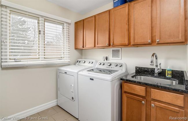 Large first-floor laundry with storage doubles as a perfect mudroom. | Image 13