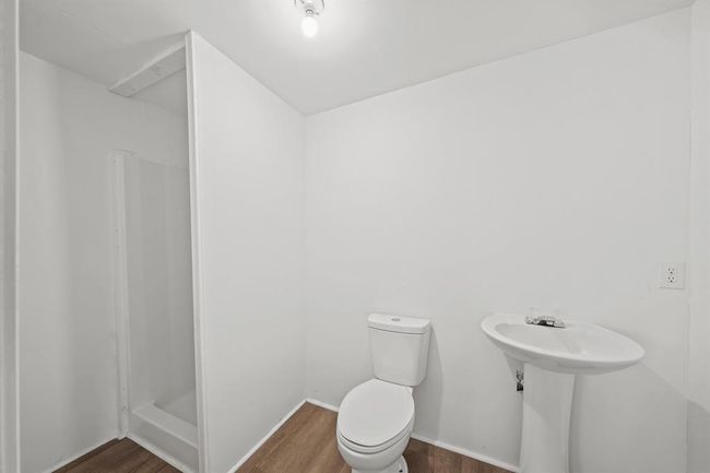 Secondary bathroom, featuring vinyl plank floors and a separate shower. | Image 16