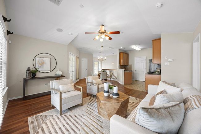 Living room with vinyl wood floors, a ceiling fan. | Image 10