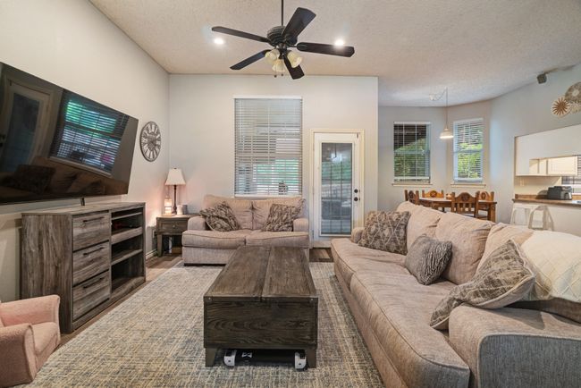 Living area with a textured ceiling, a ceiling fan, and recessed lighting | Image 4