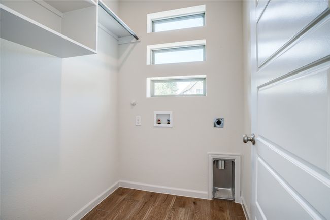 Laundry room featuring washer hookup, hookup for an electric dryer, dark wood-style floors, baseboards, and hookup for a gas dryer | Image 17