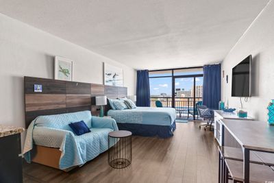 Bedroom with floor to ceiling windows, a textured ceiling, dark hardwood / wood-style floors, and access to outside | Image 3