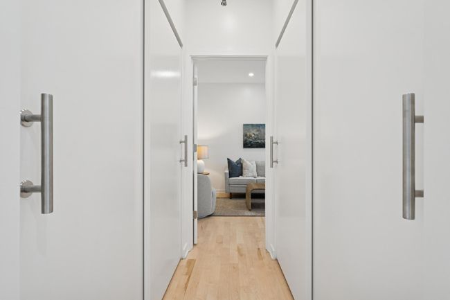 A bright hallway leads to the upper-level bedroom, with additional closet space for optimal storage and function. | Image 28