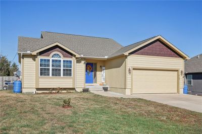 View of front of home featuring a front yard and a garage | Image 3