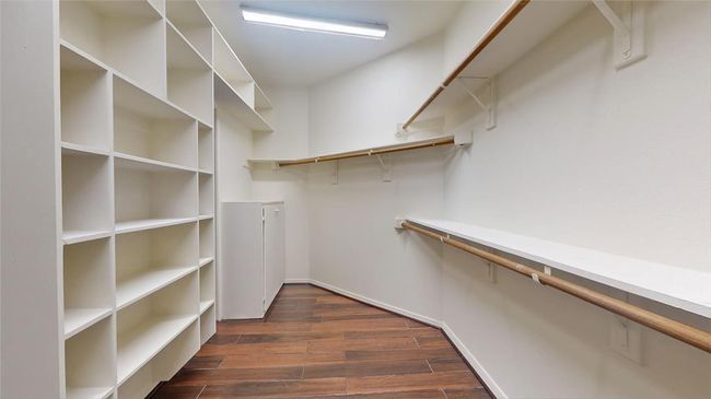 Spacious walk-in closet with ample shelving and hanging space, perfect for organizing your wardrobe. | Image 21