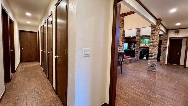 Hall with wood finished floors, decorative columns, and recessed lighting | Image 14
