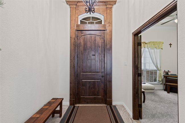 Carpeted entryway with baseboards and ornamental molding | Image 8