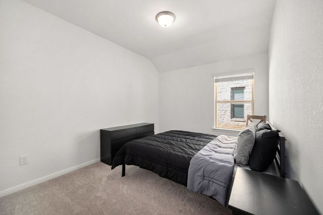 Carpeted bedroom featuring vaulted ceiling and baseboards | Image 26