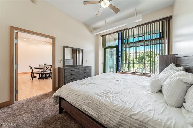 Bedroom with carpet, ceiling fan, and balcony access. | Image 18