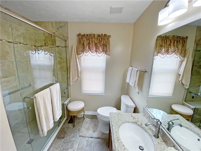 Gorgeous newer master bath with ceramic tile shower with glass doors. | Image 15