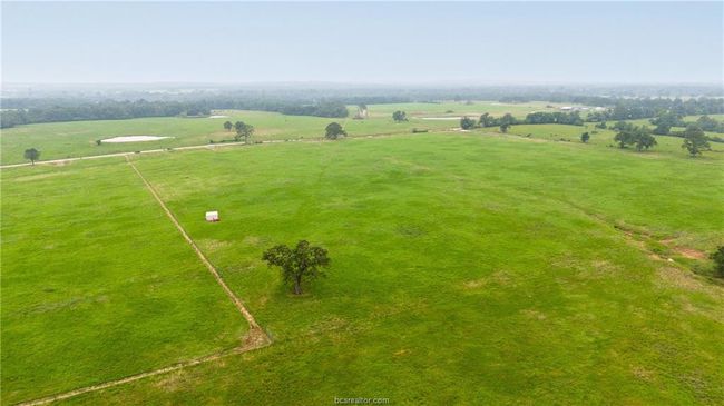 Aerial view of sparsely populated area featuring agricultural land | Image 5
