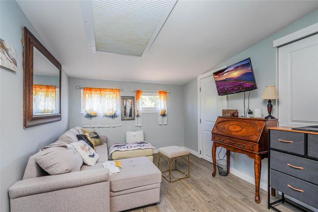 Living room with light wood-style floors and baseboards | Image 23