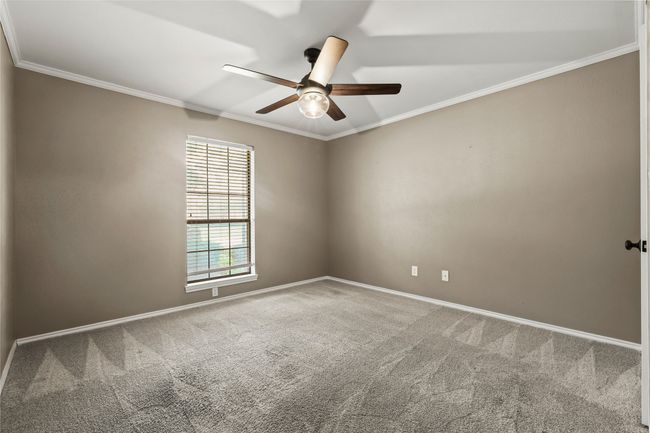 Carpeted spare room featuring ceiling fan and ornamental molding | Image 21
