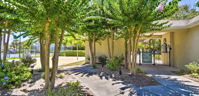 Doorway to property featuring stucco siding and a gate | Image 26