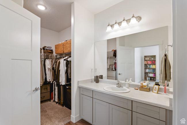 Bathroom with vanity and a walk in closet | Image 15