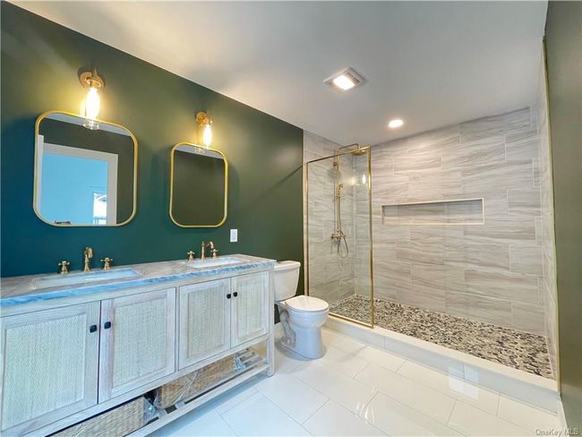 Example of the work we do. Not this house. Bathroom featuring tile patterned flooring, double sink vanity, toilet, and an enclosed shower | Image 17