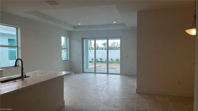 Great room with tray ceiling and casual dining area | Image 3