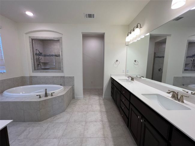 Luxurious primary bath with dual vanities, garden tub and a separate walk-in shower!! | Image 14