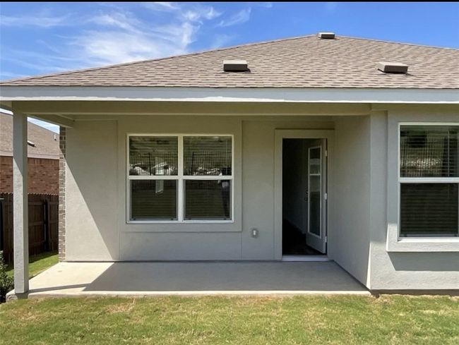 Rear view of house with a patio, stucco siding, and roof with shingles | Image 29