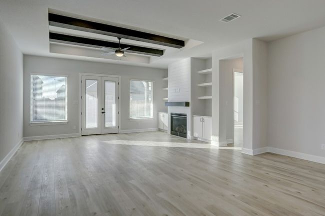 The spacious family room provides the perfect space for settling down and watching your favorite movies or chatting around the fire. | Image 4