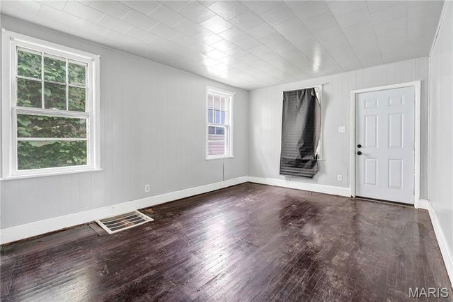 Spare room featuring hardwood / wood-style floors and wooden walls | Image 7