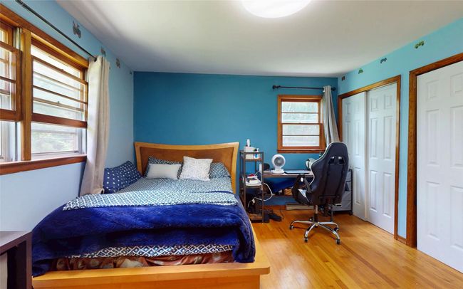 Bedroom featuring wood finished floors and two closets | Image 33