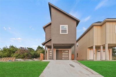 View of front of house with a garage and a front lawn | Image 1